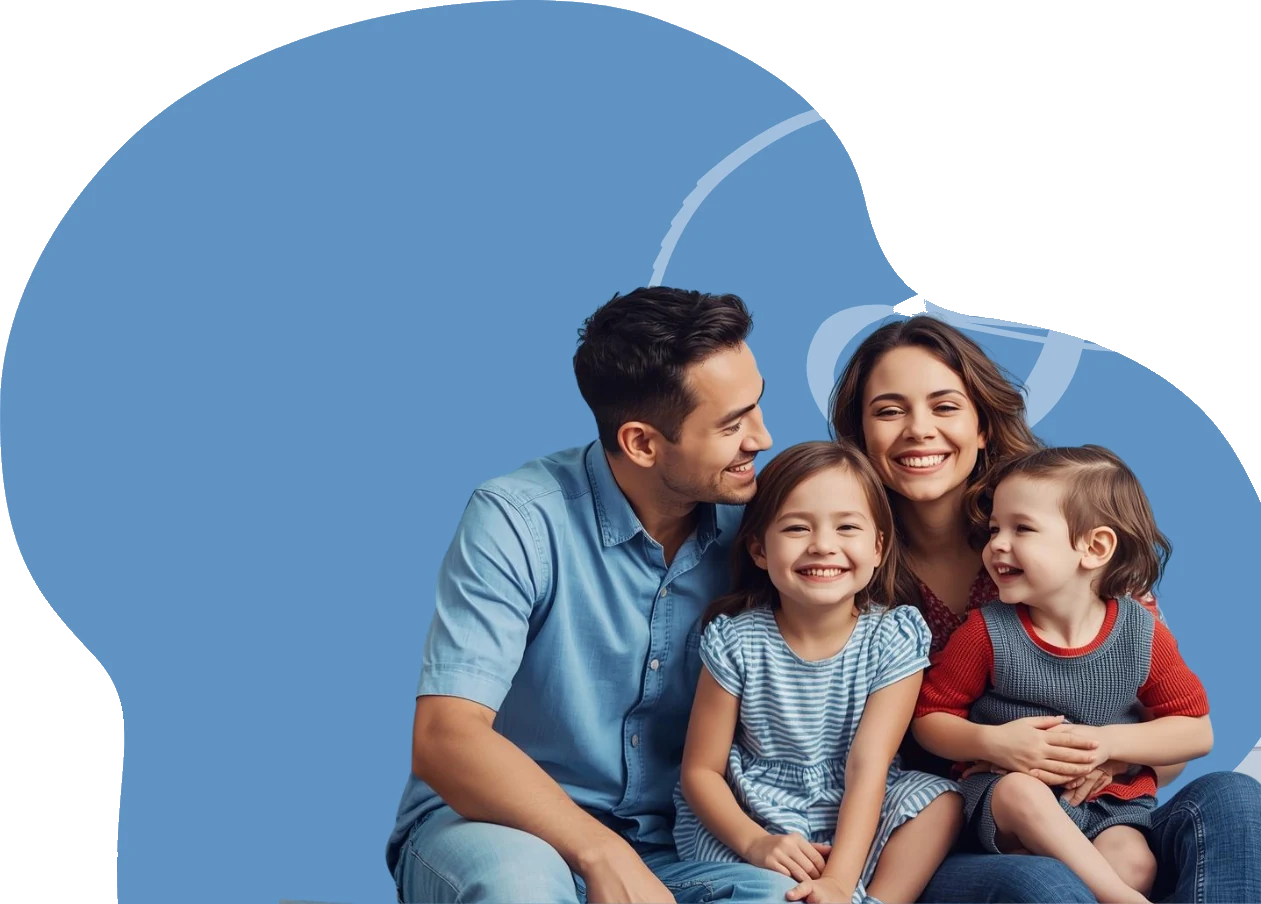 A family of four smiling together on a couch